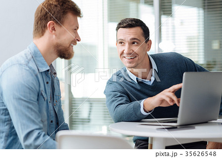 Smiling brunette talking to his new colleague Smiling brunette talking to his new colleague 35626548