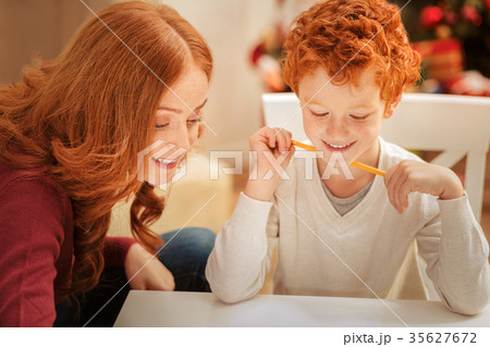 Joyful mother and son writing letter to father Joyful mother and son writing letter to father 35627672