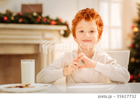 Adorable ginger kid beaming into camera Adorable ginger kid beaming into camera 35627732