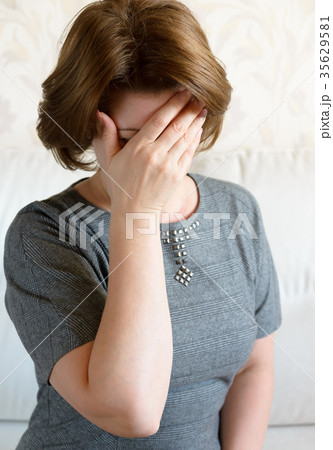 Woman covering her face with her hand. Depression Woman covering her face with her hand. Depression 35629581