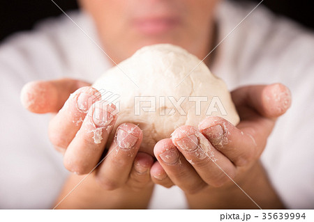 Baker holds raw dough in hands 35639994