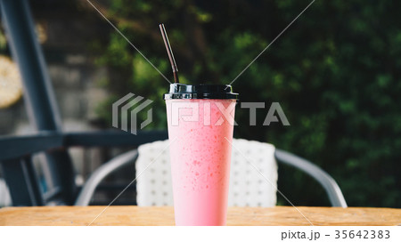 Thai style iced pink sweet milk in coffee shop Thai style iced pink sweet milk in coffee shop 35642383