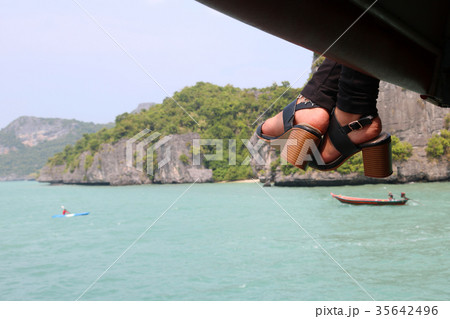 Feet and shoes of women on the tourboat 35642496