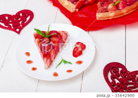 Strawberry pie on white plate and white wooden 35642900