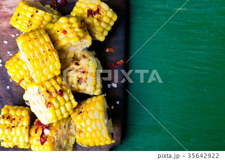 Grilled corn slices on wooden board with Grilled corn slices on wooden board with 35642922