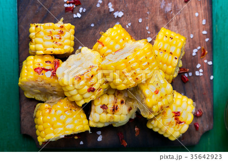 Grilled corn slices on wooden board with 35642923