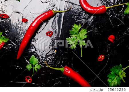 Red chili pepper and parsley on black background 35643256