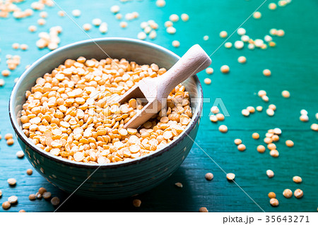 Dry yellow pea in green bowl on green background Dry yellow pea in green bowl on green background 35643271