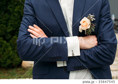 Boutonniere on the lapel of the groom Boutonniere on the lapel of the groom 35647545