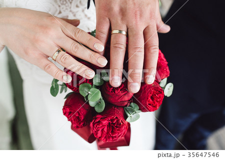 Detail of bride's bouquet and hands holding Detail of bride's bouquet and hands holding 35647546