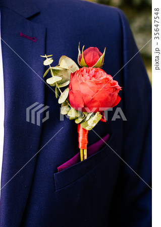 Boutonniere on the lapel of the groom 35647548