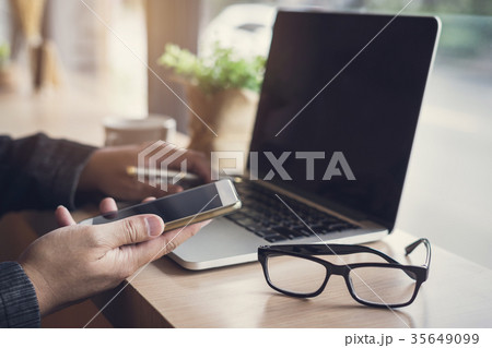 Businessman using laptop and smart phone 35649099