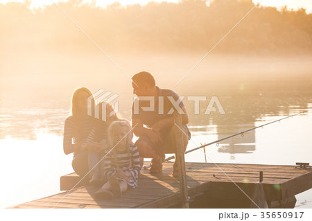 happy family sitting on the pier happy family sitting on the pier 35650917