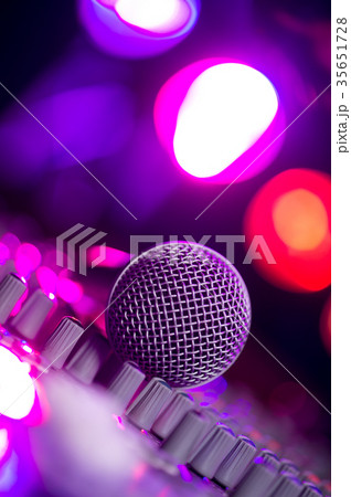 Microphone and Headphones on dirty sound mixer panel 35651728