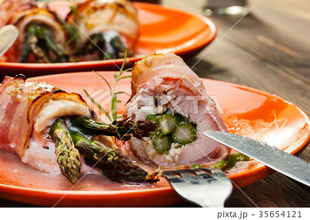Baked fresh asparagus wrapped in chicken and bacon 35654121