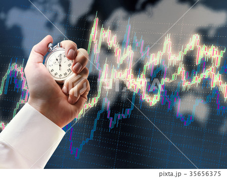 Candlestick chart graphic and stopwatch in hand 35656375
