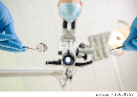 Doctor with a microscope in a dental clinic Doctor with a microscope in a dental clinic 35659255