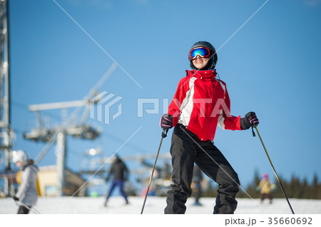 Woman skier with ski at winer resort in sunny day 35660692