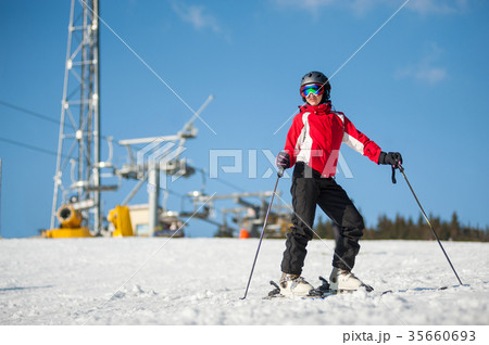Woman skier with ski at winer resort in sunny day 35660693