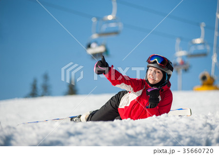 Woman skier with ski at winer resort in sunny day 35660720