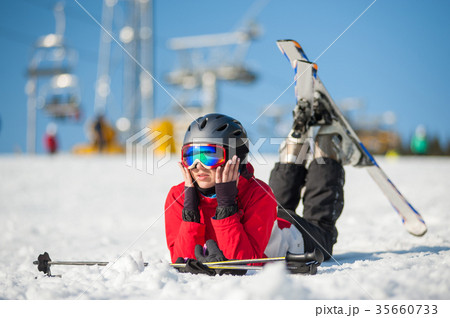 Woman skier with ski at winer resort in sunny day Woman skier with ski at winer resort in sunny day 35660733