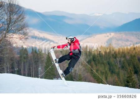 Male boarder on his snowboard at winer resort 35660826