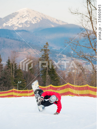 Male boarder on his snowboard at winer resort 35660845