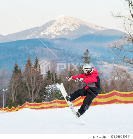 Male boarder on his snowboard at winer resort 35660847