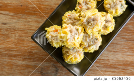 Chinese Steamed Dumpling on a black plate. Chinese Steamed Dumpling on a black plate. 35662456