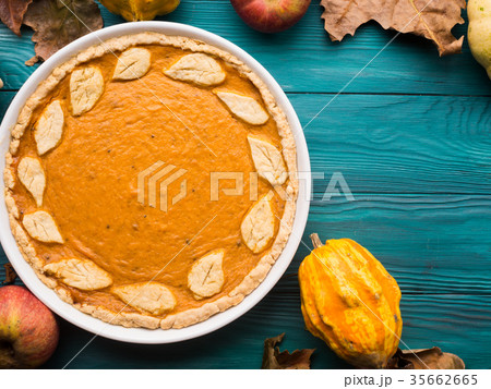 Green autumn background with pumpkin pie Green autumn background with pumpkin pie 35662665
