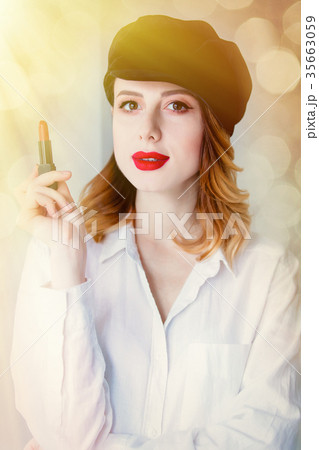Young redhead woman in hat with lipstick 35663059