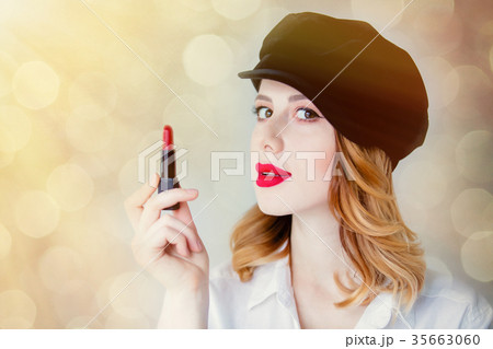 Young redhead woman in hat with lipstick Young redhead woman in hat with lipstick 35663060