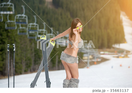 Sexy woman skier on snowy slope at ski resort 35663137