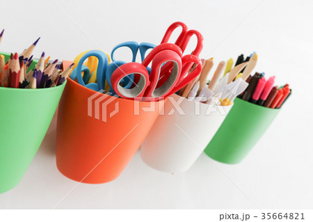 red scissors in red cup is hanged on the bar 35664821