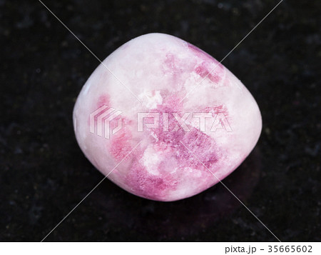 tumbled pink Sodalite gemstone on dark 35665602