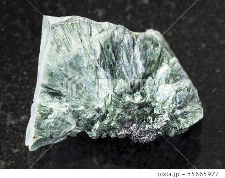 rough clinochlore stone on dark background 35665972