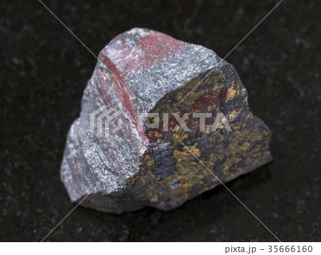 raw jaspilite (ferruginous quartzite) on dark 35666160