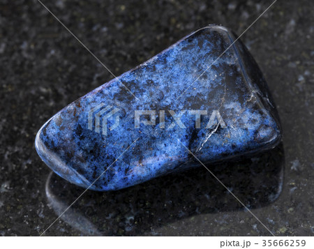 polished dumortierite gem on dark background 35666259