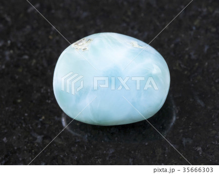 tumbled Larimar gemstone on dark background 35666303