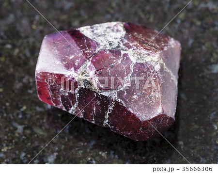 raw crystal of red garnet gemstone on dark 35666306