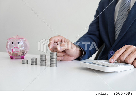 Businessman using calculator to analysis business investment and 35667698