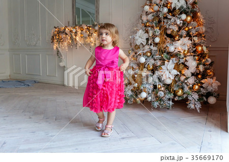 young girl near a Christmas tree young girl near a Christmas tree 35669170