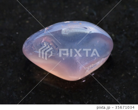 tumbled translucent moonstone gemstone on dark 35671034
