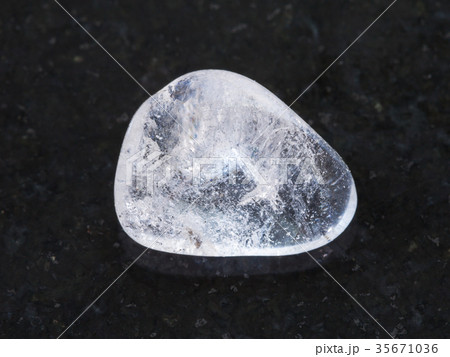 polished Rock-crystal gem stone on dark 35671036