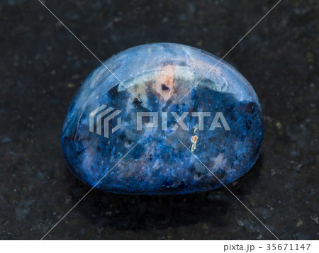 polished dumortierite gem stone on dark 35671147