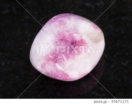polished pink Sodalite gemstone on dark 35671171