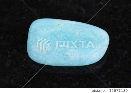 tumbled Aquamarine (blue beryl) gemstone on dark tumbled Aquamarine (blue beryl) gemstone on dark 35671180