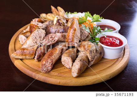 Assorted sausages with sauce 35671193