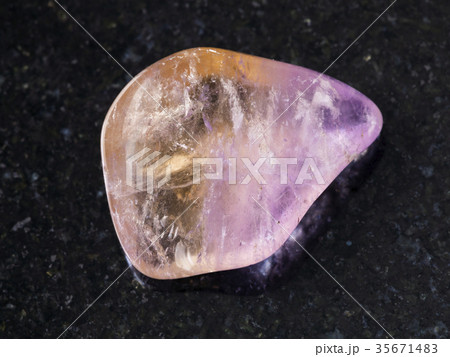 polished Ametrine gemstone on dark background polished Ametrine gemstone on dark background 35671483