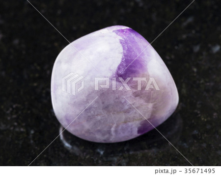 tumbled amethyst gem stone on dark background tumbled amethyst gem stone on dark background 35671495